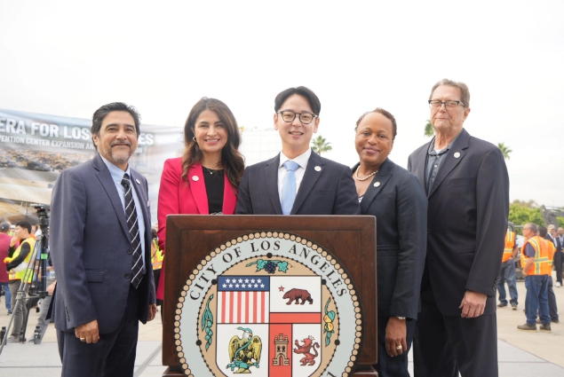 The five Los Angeles Board of Public Works commissioners standing together behind the City of Los Angeles podium